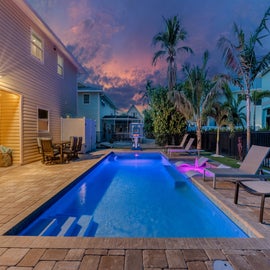Stunning twilight view of the pool with soft ambient lighting