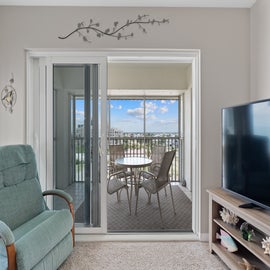 Screened in outside patio with outdoor seating.
