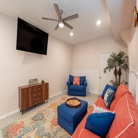 First floor Living room, with mounted tv and access to pool- ground level