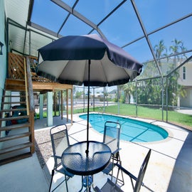 Relax in the shaded lanai by the pool.