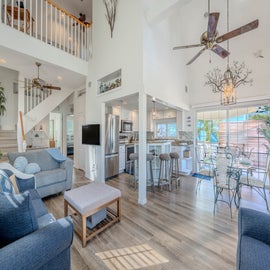 Bright open living room with vaulted ceilings.