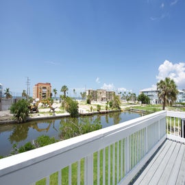 view of canal and beach from deck