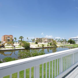 view of canal and beach from deck