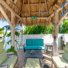 Enjoy the shade under the tiki poolside.