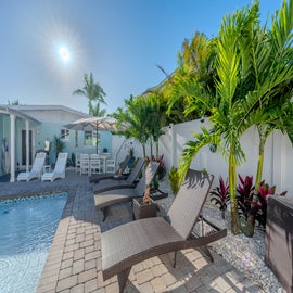 Lounge poolside in this green tropical paradise.