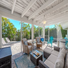 Relax in the shade in screened in patio area.